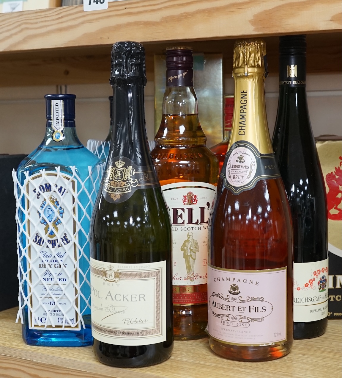 Nine various bottles of wine and spirits to include Albert Et Fils champagne, Bells Scotch whisky and Bombay Sapphire gin. Condition - good, storage history unknown